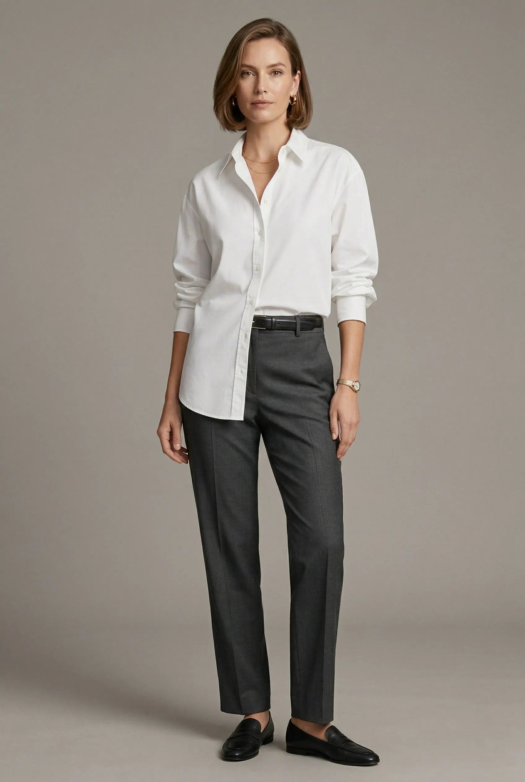 Woman wearing a crisp white shirt and charcoal trousers